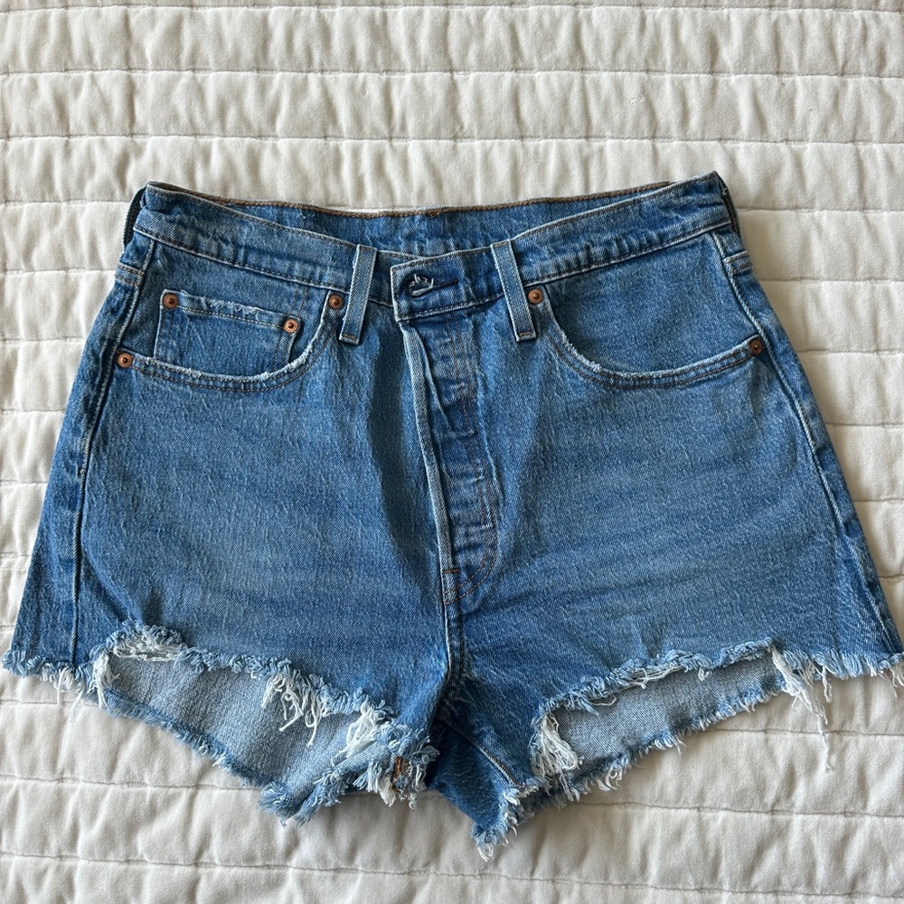Levi’s 501 cutoffs - tags removed never worn. Perfect blue distressing